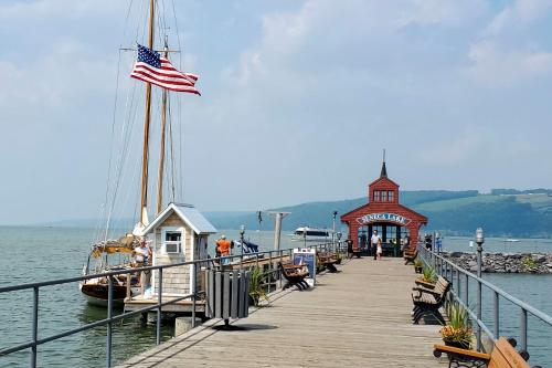 a dock with a boat and an american flag on it at Newly Renovated Penn Yan Apartment Less Than 1 Mi to Lake! in Penn Yan