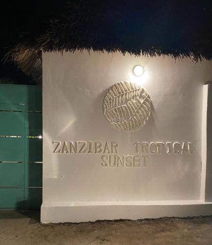 a sign for the zambian tropical sunset at night at Zanzibar Tropical Sunset Boutique Hotel - Adults Only in Kiwengwa