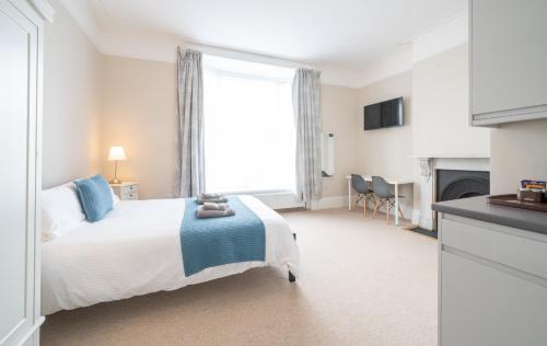 a bedroom with a bed and a large window at The Veteran Hotel & Bar in Ryde