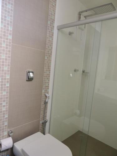 a bathroom with a shower and a toilet at Star Hotel in Itaperuna
