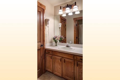 a bathroom with a sink and a mirror at Bear Claw 312 - Ski-in Ski-out Condo! in Steamboat Springs