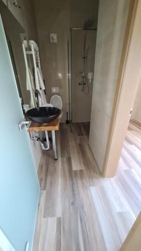 a bathroom with a sink and a shower at KASNAR ROOMS in Zagreb