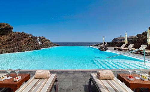 a large swimming pool with a view of the ocean at Hotel Hacienda del Conde Meliá Collection Golf & Spa - Adults Only in Buenavista del Norte