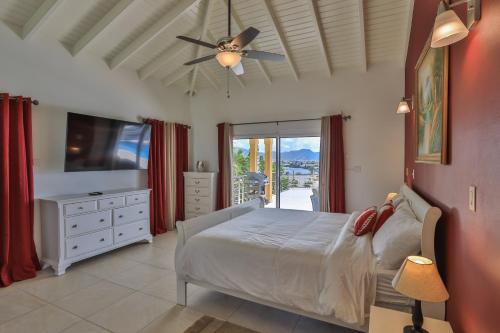 a bedroom with a bed and a ceiling fan at Reflection Z 5 Star Villa in Maho Reef