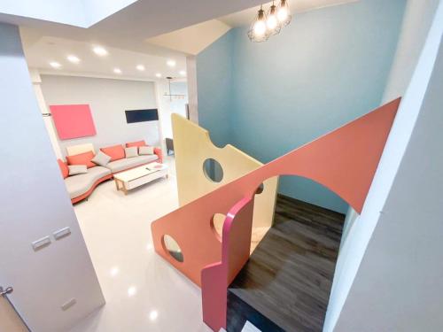 a room with a staircase and a living room at Chill鬆口氣-包棟民宿 in Yilan City
