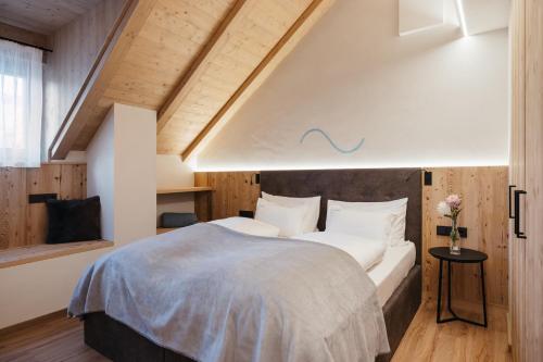 a bedroom with a large bed with white pillows at Alpine Chalet Sauter in San Vigilio Di Marebbe