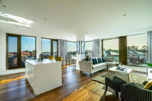 a living room with a couch and a table at Skyview Retreat @ Ryedale House in York