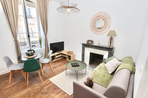 a living room with a couch and a fireplace at Napoléon Gare 3 T2 RDC ByLocly in Pontivy