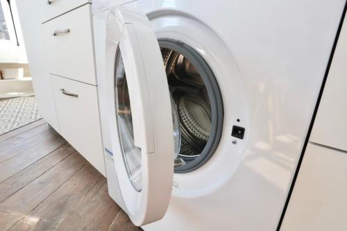 a white washing machine in a white laundry room at Napoléon Gare 1 STUDIO Lumineux ByLocly in Pontivy