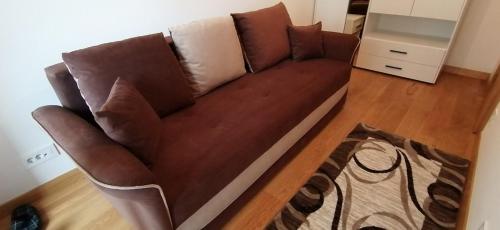 a brown couch sitting in a living room at MoonZe Gate in Belgrade