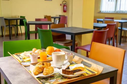 a tray of breakfast food on a table in a cafeteria at Hotel Trasimeno in Passignano sul Trasimeno