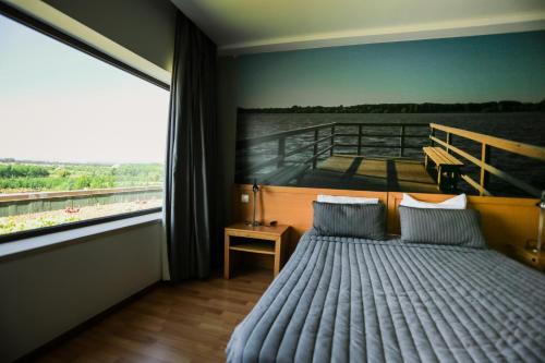 a bedroom with a bed in front of a boat at Burguezia do Leitão in Casal Comba
