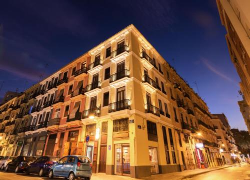 a large building with cars parked in front of it at Hotel 19-30 Valencia in Valencia