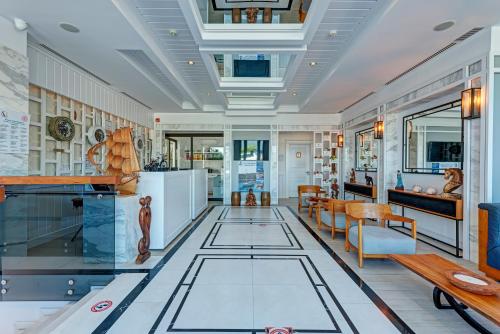 a living room with a glass floor and a dining room at Meis Exclusive Hotel in Kaş