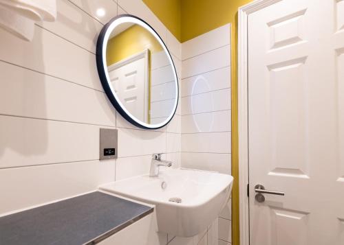 a bathroom with a sink and a mirror at Byron Hotel in London