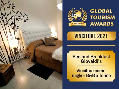 a poster for the global tourism awards with a bed and a plant at B&B Giovaldi's Torino in Turin