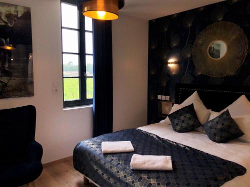 a bedroom with a bed with two towels on it at Chambres d'hôte & Gîte Château Le Conte - Saint Emilion in Saint-Émilion