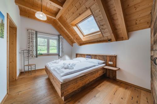 a bedroom with a bed and a wooden ceiling at Penthouse Weiglhof in Russbach am Pass Gschütt