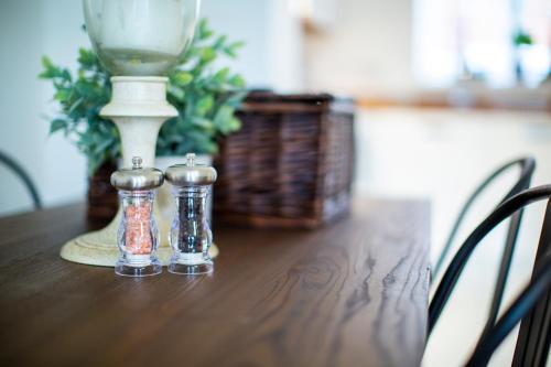 two salt and pepper shakers sitting on a table at Modern House with FREE Private Parking, WIFI & Netflix in Stratford-upon-Avon