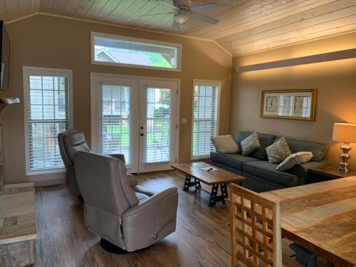 a living room with a couch and a table at Carr's Northside Hotel and Cottages in Gatlinburg