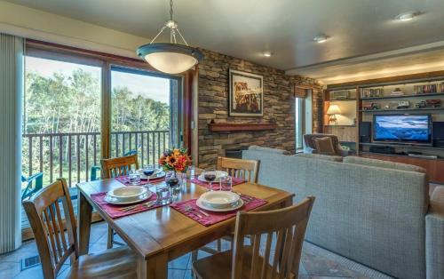 uma sala de jantar com uma mesa de madeira e cadeiras em Bear Claw 201 - Bear Claw I Building em Steamboat Springs
