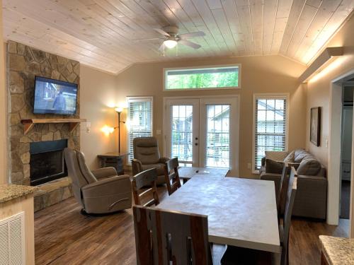 a living room with a table and a fireplace at Carr's Northside Hotel and Cottages in Gatlinburg