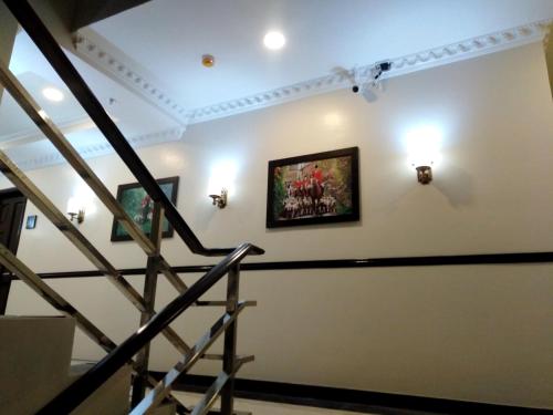 a staircase in a building with a painting on the wall at Venezia Suites Hotel Iloilo in Iloilo City