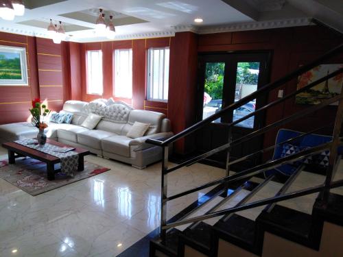 a living room with a couch and a table at Venezia Suites Hotel Iloilo in Iloilo City