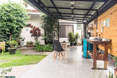 an outdoor kitchen with a table and chairs on a patio at Terida Airport B&B in Alajuela City