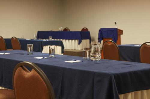 a table with a blue table cloth and glasses on it at Hotel Unu in Huancayo