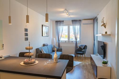 a living room with a couch and a table in a room at Flexible SelfCheckIns 25 - Zagreb - Garage - Loggia - New - Luxury in Zagreb