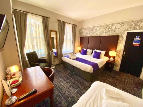 a hotel room with a bed and a desk at The Red Cow - Guest House in Richmond upon Thames