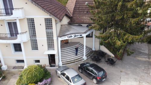 a man standing on the front porch of a house at B&B Villa Pipacs in Feketić