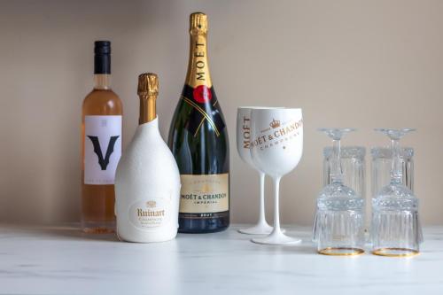 a group of wine bottles and glasses on a table at Boutique Hotel No5 in Bergen op Zoom