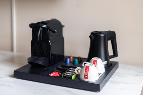 a coffee maker on a black stand on a counter at Boutique Hotel No5 in Bergen op Zoom
