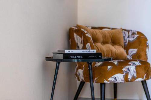 a table with books on it next to a chair at Boutique Hotel No5 in Bergen op Zoom