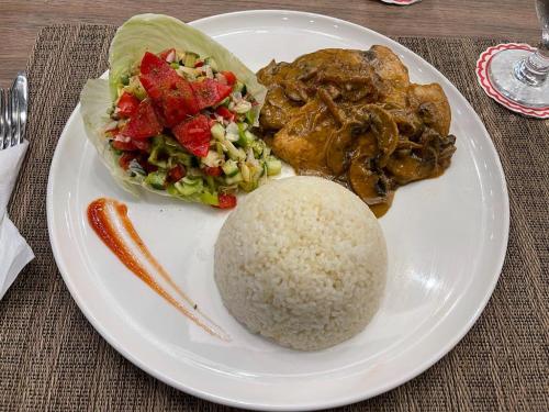 a plate of food with rice and meat and vegetables at Andalusia Blue Beach Hurghada in Hurghada