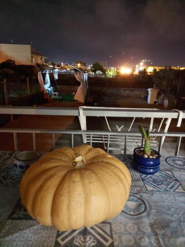 a pumpkin sitting on top of a balcony at night at B&B Petra Hercules in Torre Annunziata