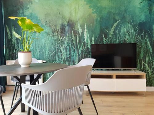Televízia a/alebo spoločenská miestnosť v ubytovaní Apartament Triventi 88 z Widokiem na Śnieżkę - 5D Apartamenty