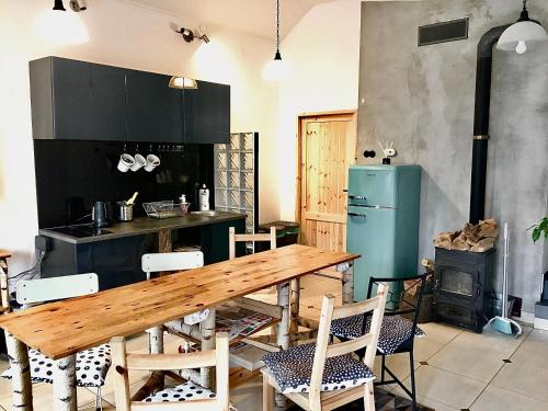 a kitchen with a wooden table and chairs at Hostel PrzyMorze in Gdańsk