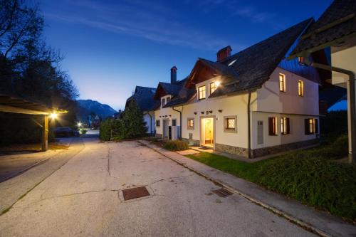 a house on a street at night at Apartmaji Potepuh in Kranjska Gora