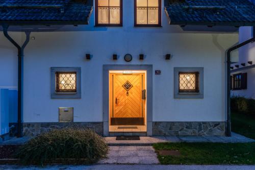 a yellow door on the side of a building at Apartmaji Potepuh in Kranjska Gora