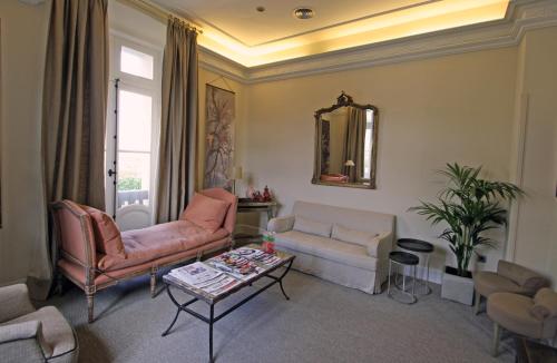 a living room with two couches and a table at Hotel Villa Rosario in Ribadesella