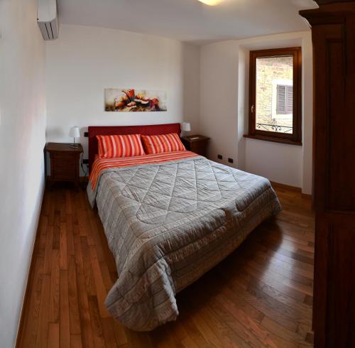 a bedroom with a large bed with red pillows at Appartamento Clary in Montecatini Terme