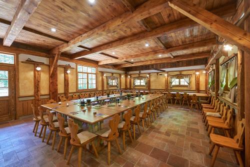 a large room with a long table and chairs at Eko hiša-Eco House Na razpotju in Solčava