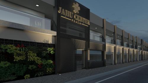a building with a sign on the side of it at Jahu Center Plaza Flats in Jaú