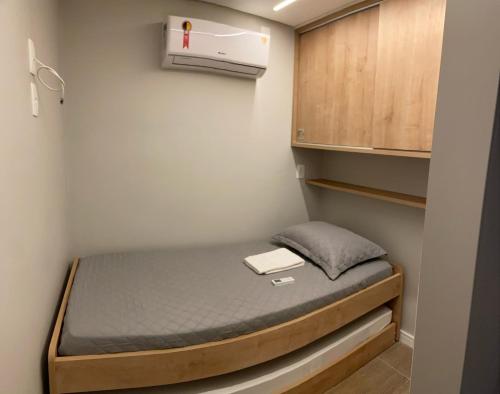 a small room with a bed and a heater at Nannai - Muro Alto - Alto Padrão in Porto De Galinhas