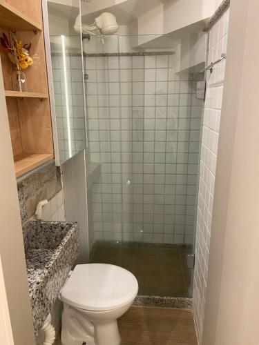 a bathroom with a toilet and a shower at Nannai - Muro Alto - Alto Padrão in Porto De Galinhas