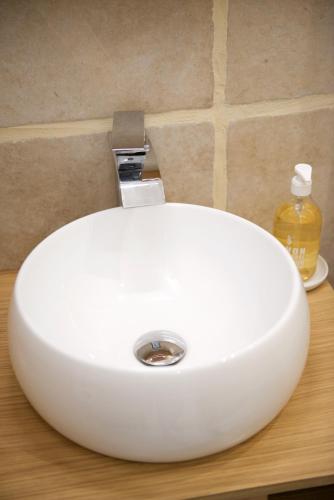 a white sink sitting on a counter in a bathroom at CHARMING Parisian Apartment WITH AIR CONDITIONING - CLIMATISATION & 2 BEDROOMS - Batignolles PARIS in Paris