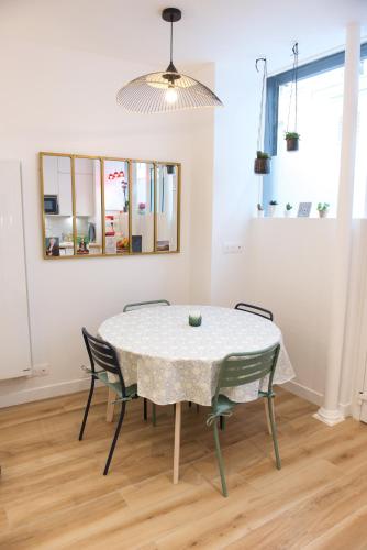 a dining room with a table and chairs at CHARMING Parisian Apartment WITH AIR CONDITIONING - CLIMATISATION & 2 BEDROOMS - Batignolles PARIS in Paris